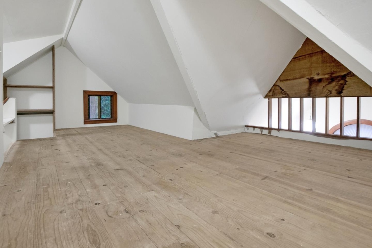 Attic/loft for storage; low ceiling, window.