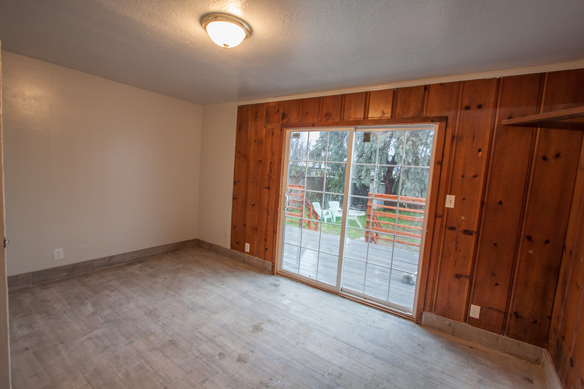 The downstairs bedroom is 11' x 15'.  It has a bit of vintage knotty pine planking and great access to the deck.