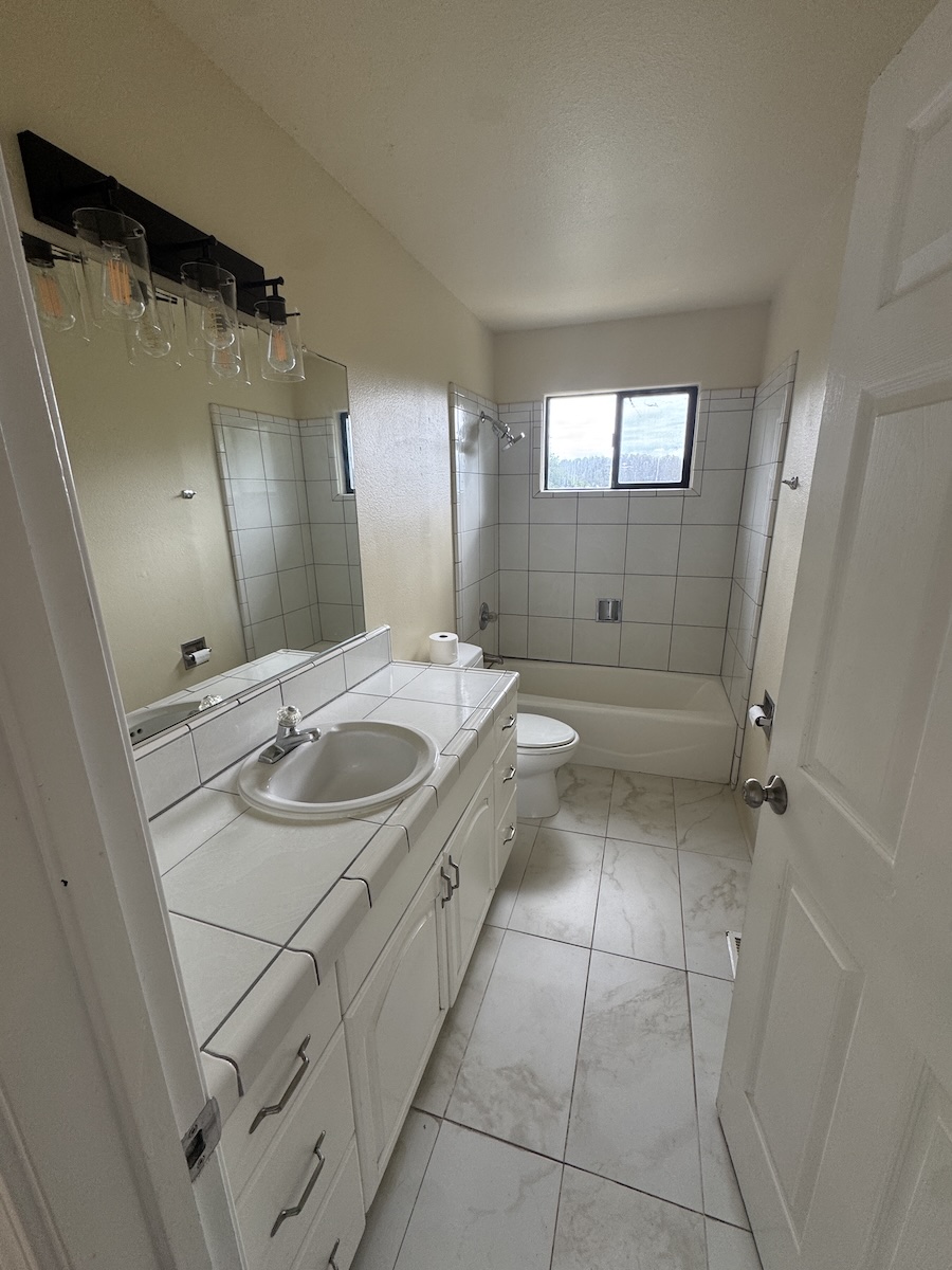 The bathroom is bright, with plenty of counter and storage.