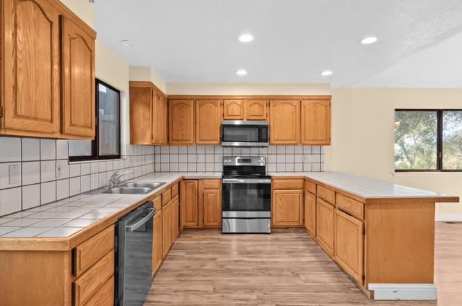 Spacious kitchen (11 x 18) has modern appliances as well as laundry hookups for either gas or electric dryer.