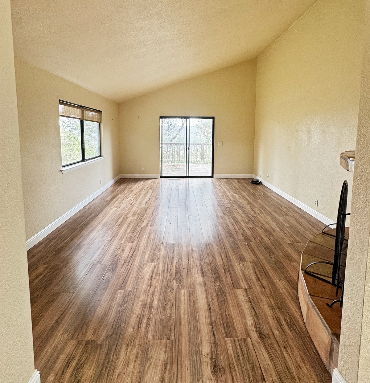 Glass Doors open on to a deck high in the oak trees with a view of Aptos.