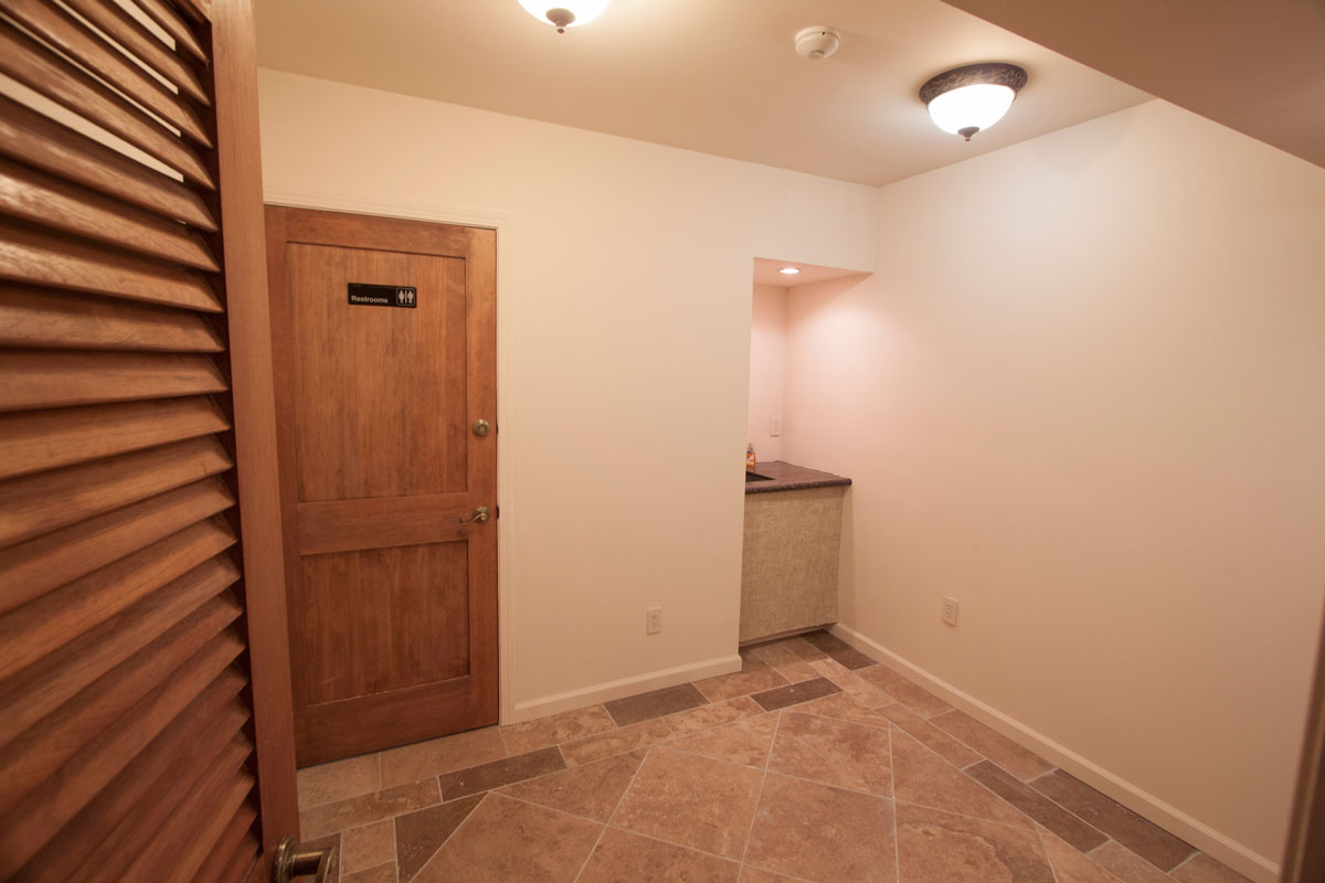 Side office with sink; restroom behind door.