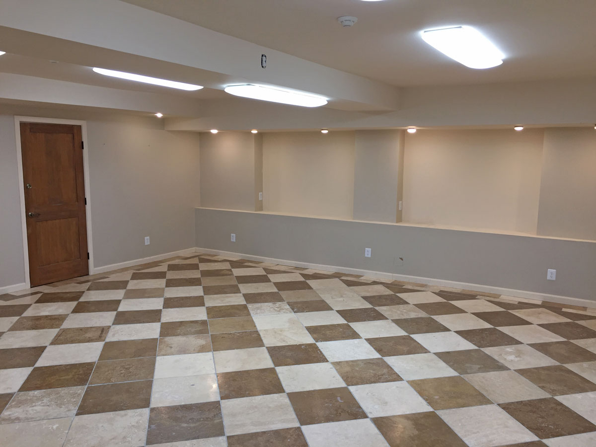 Main room toward hall and shared restroom.